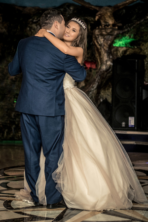 Bride and groom kissing. couple newlyweds bride and groom at a wedding in a restaurant.の写真素材