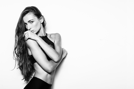 Young sexy woman in studio. Black and white backgroundの写真素材