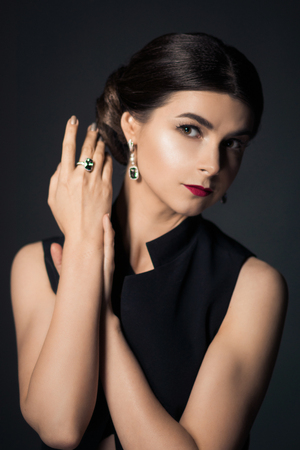 Fashionable woman with clean skin on black background. Retro portraitの写真素材