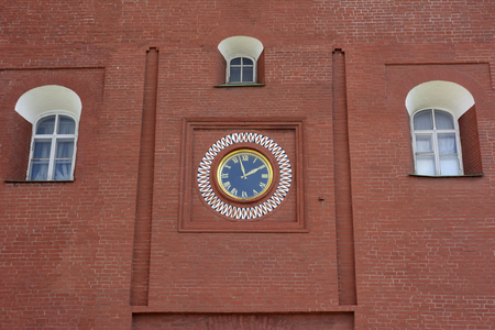 The clock on the brick wall of the Troitskaya tower of the Moscow Kremlinの写真素材