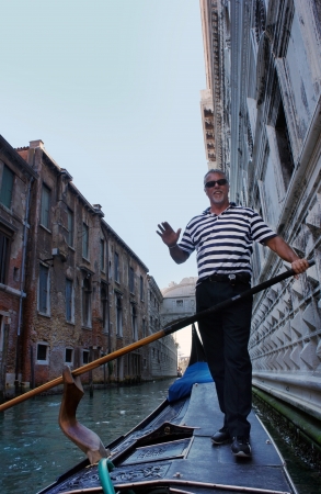 VENICE-JUNE 23   Gondolier rides gondola on the canals of Venice on June 23,2013  Gondola - is one of the symbols of Venice and  major mode of touristic transport  in Venice, Italy  のeditorial素材