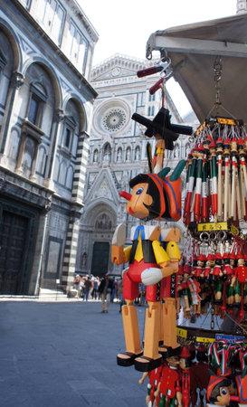 Souvenirs Pinocchio wooden italian marionette in Piazza del Duomo, Florence, Tuscany, Italyのeditorial素材