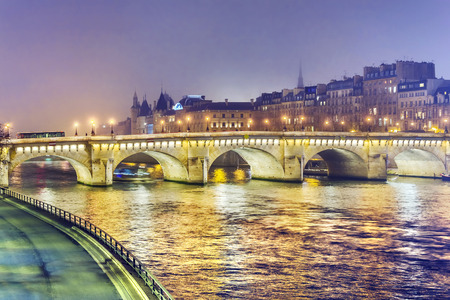 Night view of  Paris, France. Illuminated Pont neuf (New Bridge) is oldest bridge across the river Seine.の写真素材