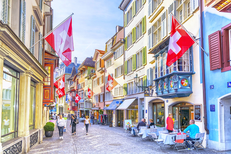 ZURICH, SWITZERLAND - APRIL 12, 2017: Augustinergasse pedestrian Street with colorful buildings with cafe and restaurants in the old city center of Zurich in Switzerlandのeditorial素材
