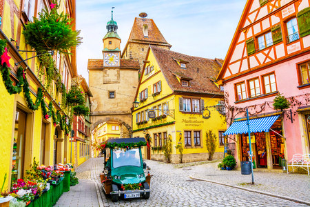 ROTHENBURG OB DER TAUBER, GERMANY - December 13, 2016: Touristic retro car on picturesque street, decorated for Christmas holiday in Bavaria, Germanyのeditorial素材