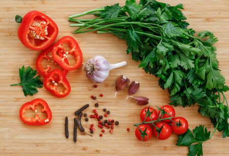 Fresh vegetables on the table. Food background. Flat lay. Cherry tomatoes, a bunch of parsley,...