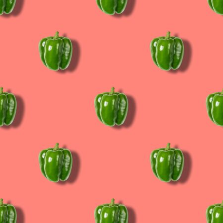 Seamless pattern with green pepper on pink background. Vegetable pattern. Abstract background.