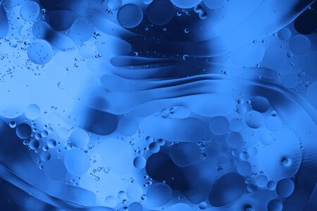 Classic Blue background. Color of the year 2020. Oil bubbles in the water.