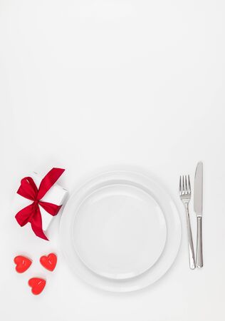 Valentines day or romantic dinner background. Festive romantic table setting on a white background. Valentine's card. Copy space, top view, flat lay.の写真素材