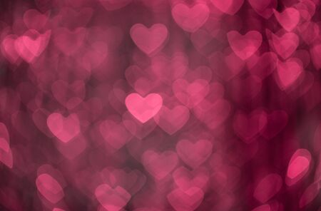 Pink hearts abstract bokeh background. Valentines day texture. Defocused shiny sequins.