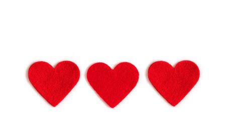 Red textile hearts on a white background. Valentines day or mothers day background. Copy space, top view, flat lay.の写真素材