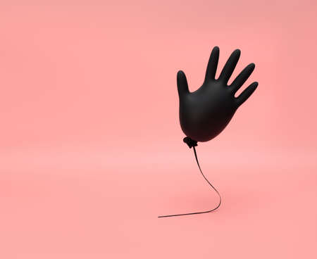Black inflated flying rubber glove on a pink background. Prevention and protection against coronavirus, covid-19. Minimal medicine concept. Copy space.の写真素材