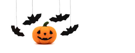 Halloween pumpkin and bats isolated on a white background. Copy space, banner. Toy pumpkin made of wool. Halloween concept.の写真素材