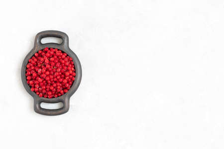 Frozen red currant in a wooden plate on a white background. Frozen red berries. Space for text. View from above.の写真素材