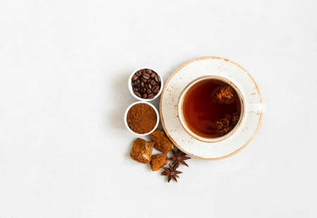 Cup with mushroom chaga drink and coffee on a white background. Trendy superfood. View from above. Copy space.の写真素材