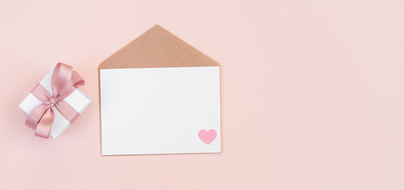 Valentines day greeting card. Empty card with envelope and gift on pink background. Valentines day...