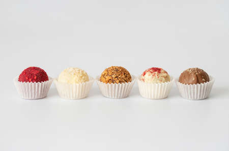 Homemade candies or energy balls with chocolate, coconut, karkade and dried fruit on a white background. Space for the text.の写真素材