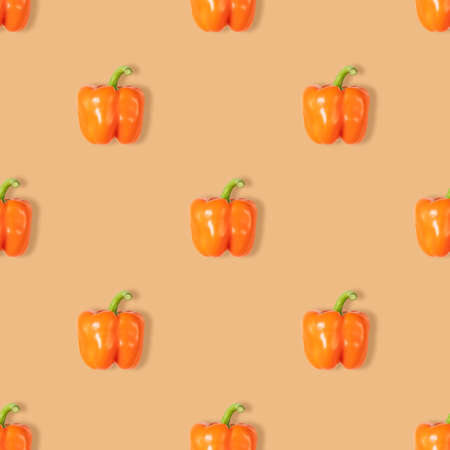 Orange pepper seamless pattern on orange background. Vegetable pattern for design. Abstract food background. Top view, flat lay.の写真素材