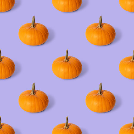 Seamless pattern with a pumpkin on a purple background. Autumn pumpkin background. Side view.の写真素材