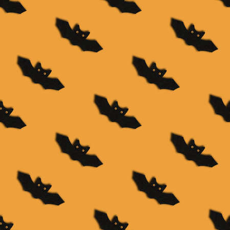 Seamless pattern with bats on orange background. Halloween abstract background. Design for packaging.の写真素材