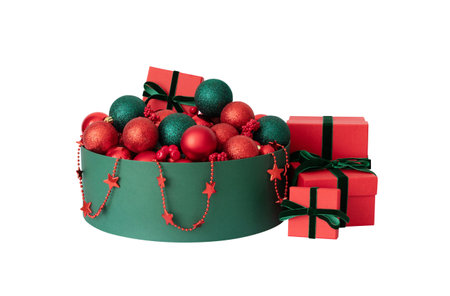 A green box with red Christmas decorations and gift boxes isolated on a white background. New Year decor.の写真素材
