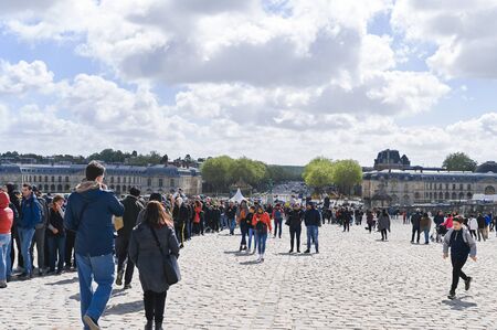 Gateway to the palace of Versailles. People at the main entrance and blue skyのeditorial素材