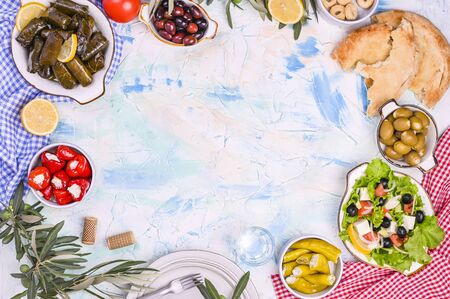 Turkish cabbage rolls and various snacks of national cuisine. Rice in grape leaves and olives. Food for a traditional oriental lunch. Free space for text, empty plateの写真素材