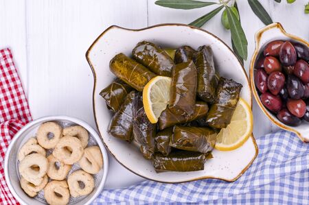 Turkish cabbage rolls and various snacks of national cuisine. Rice in grape leaves and olives. Food for a traditional oriental lunchの写真素材