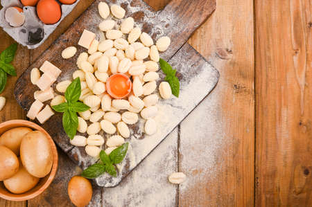 Gnocchi with potatoes. Traditional italian food from Rome, Sardinia, south of italy. Homemade gnocchi with parmesan, egg, cornmeal (semolina). On a wooden table. High quality photo. Copy spaceの写真素材