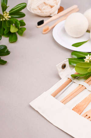 Eco craft paper tableware. A box of paper for food, cotton bag, Toothbrush, plate, forks, knives, on a gray background. world is free of plastic. Recycling concept eco-friendly . Close-Up.の写真素材