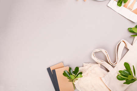 Eco craft paper tableware a bag of cotton, a net for fruit, a notebook on a gray background. Zero waste, eco friendly, plastic. Recycling concept eco-friendly . Copy space. Flat lay .の写真素材