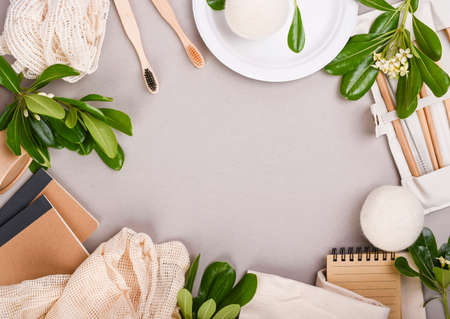 Eco craft paper tableware. A box of paper for food, packaging, Toothbrush, plate, forks, knives, eco bag with fruits on a gray background. world is free of plastic. Recycling concept eco-friendly .の写真素材