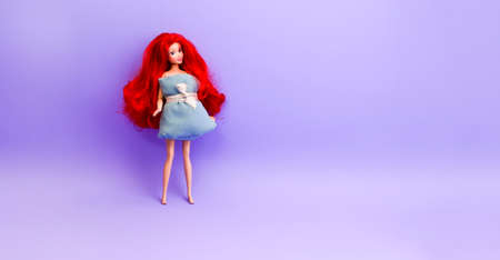 April 28, 2020 Bologna, Italy. Doll with an imitating girl with a pillow for challenge on a lilac background. Creative idea. Pillow Challenge due to stay home isolation. Caronavirus Quarantineのeditorial素材