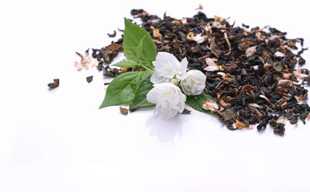 Green tea with jasmine on a white background. Traditional oriental health drink. Dry tea. High quality photoの写真素材
