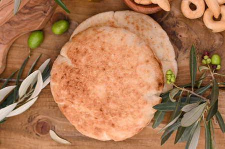 Fresh and tasty ciabatta on a wooden background.