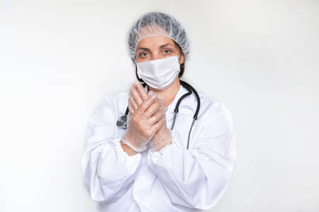 Dotkor woman in white coat, gloves and mask. Protection against infections during the COVID...