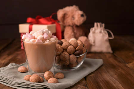 Dutch holiday Sinterklaas. Fragrant black coffee and and cocoa with marshmallows , traditional hollands sweets. Concept for children party Saint Nicholas day five december. Copy sapce.の写真素材