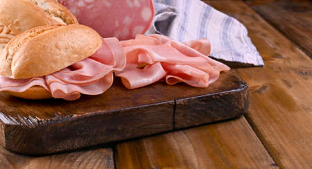 Mortadella and bread. Traditional Italian food for a pre-dinner starter in the restaurant. Typical food Emilia Romagna and the city of Bologna. High quality photo. Banner . Copy spaceの写真素材