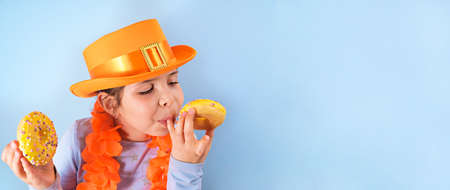 Kings Day in Holland. Traditional festival on April 27 in the Netherlands. A little girl in a...