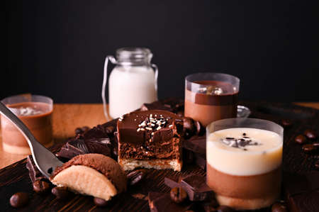 Dessert cut. Dessert cutPanna Cotta with chocolate. Traditional Italian dessert, a person tastes a portion with a small fork. Copy spaceの写真素材