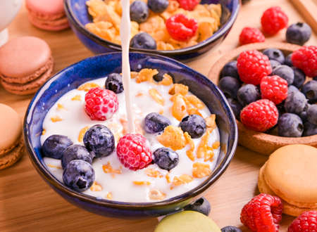 Muesli with berries and milk. Delicious healthy breakfast. Flakes and sweet pastries. High quality photoの写真素材