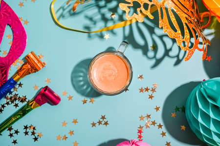 Traditional carnival and food TYPICAL. Coffee, Sfrappole or chiachiere or angel wings and aromatic coffee on a bright blue background. Copy spaceの写真素材