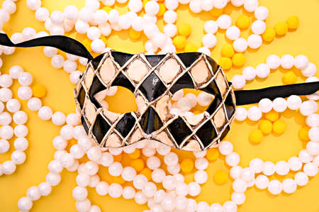 Carnival mask and festive garlands on a bright background. Image for a cover or poster. Venice concept in italy. High quality photoの写真素材