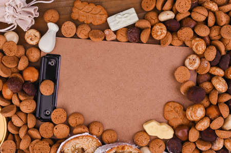 A traditional Dutch holiday for children of Sinterklaas. Winter holidays in Europe and the Netherlands. background with pepernoten and traditional strooigoed sweets. Form for writing text. Flat layの写真素材