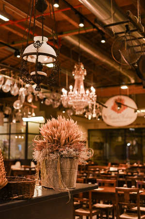 Decor of wheat in a restaurant. Vintage photo with tinted processing. Copy spaceの写真素材