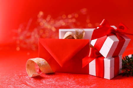 Christmas background red and selective focus. Boxes with gifts and christmas decor. Holiday card with Copy spaceの写真素材