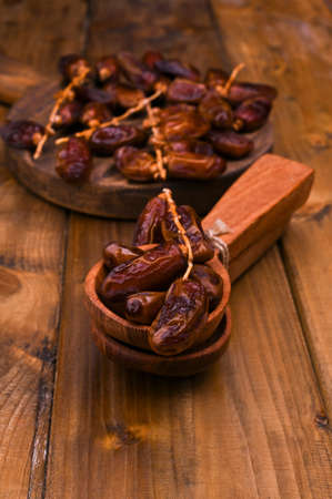Raw Organic Medjool Dates Ready to Eat . East sweets on a wooden background. Copy space.