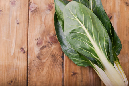 Fresh chard on a wooden table. Traditional italian food. Free background for text. View from above. copy space .の写真素材