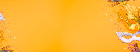 Carnival mask on a yellow background. Decor for a traditional Italian holiday. Copy space. Flat lay. Banner.の写真素材