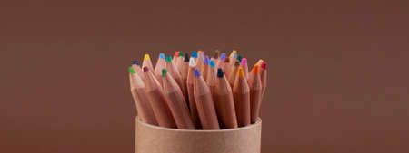 Eco colored pencils made from recycled material. A set of wooden pencils in a box. Top view. Free space for text. High quality photo. Banner . Long formatの写真素材
